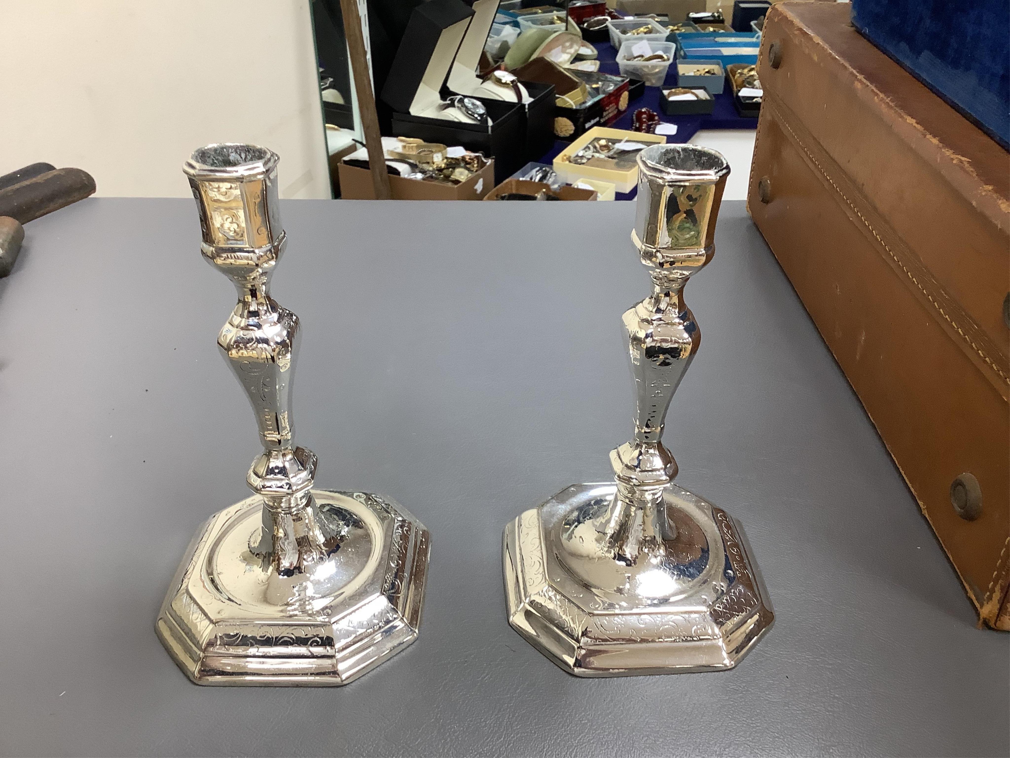 A pair of white metal candlesticks, a silver plated teapot circular tureen and cover spoons and forks and four spirit labels and large tray. Tray 73cm wide
